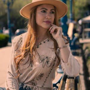 Woman in Embroidered Blouse and Hat